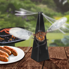 Fly Repellent Fan - Black tapered device with spinning blades deflects a fly near a grill and plate of sausages on a wooden table