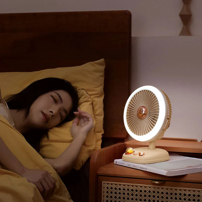 Standing Fan - Small desk fan with ring light sits on a nightstand beside a sleeping person in bed