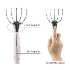Five-prong handheld massager showing two sensing areas and a hand in correct holding posture.