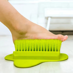 A bare foot hovering above bristles of a foot scrubber brush with pumice stone exfoliator.
