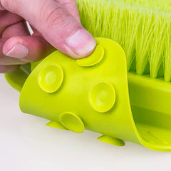 Close-up of a green plastic brush base with multiple circular suction cups on its underside