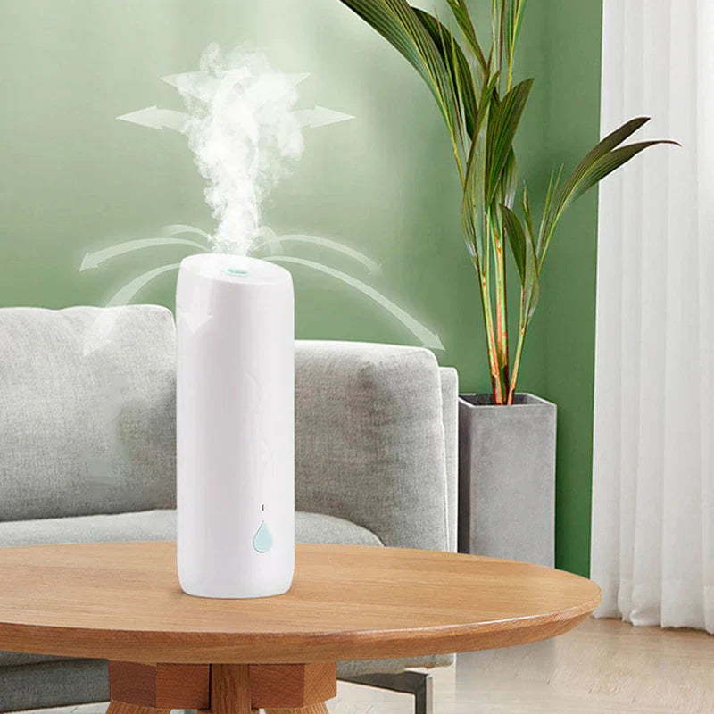 Formaldehyde Remover Air Purifier Gel Box - White humidifier emitting mist while placed on a wooden table, with a sofa and plant in the background