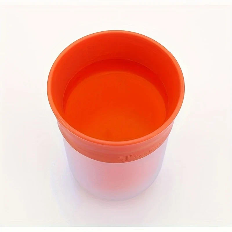 Fruit Infuser Water Bottle - Top-down view of an orange two-tone cup showing its open interior on a white surface