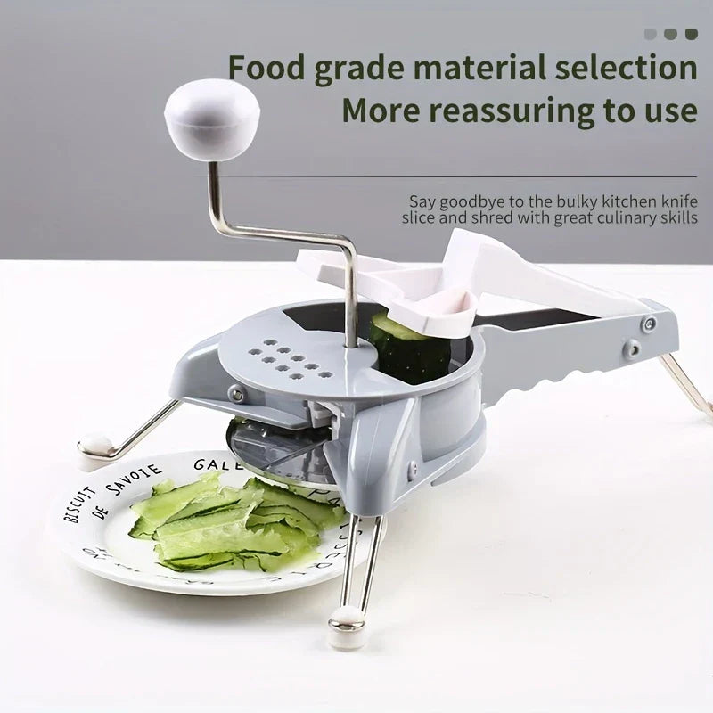 Fullstar Vegetable Chopper - Hand-cranked manual slicer processing a cucumber, with sliced cucumber falling onto a plate below