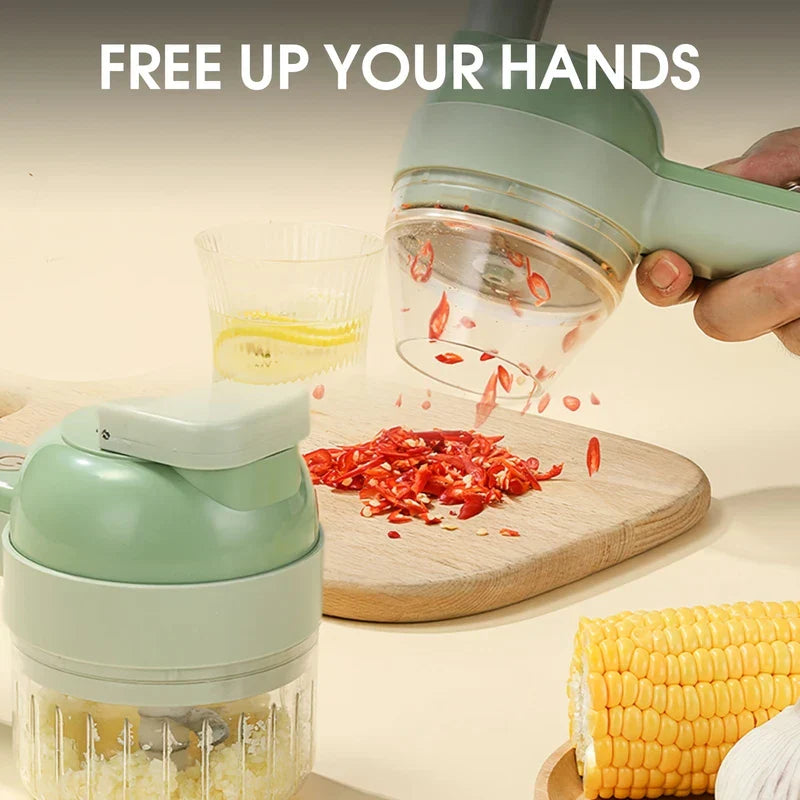 Electric Vegetable Chopper - Hand holding a light green handheld chopper pouring cut red chili onto a wooden cutting board, with a second chopper holding minced garlic, corn and garlic nearby.