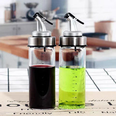 Glass Cruet - Two dispensers holding dark and light green cooking liquids placed on a kitchen countertop