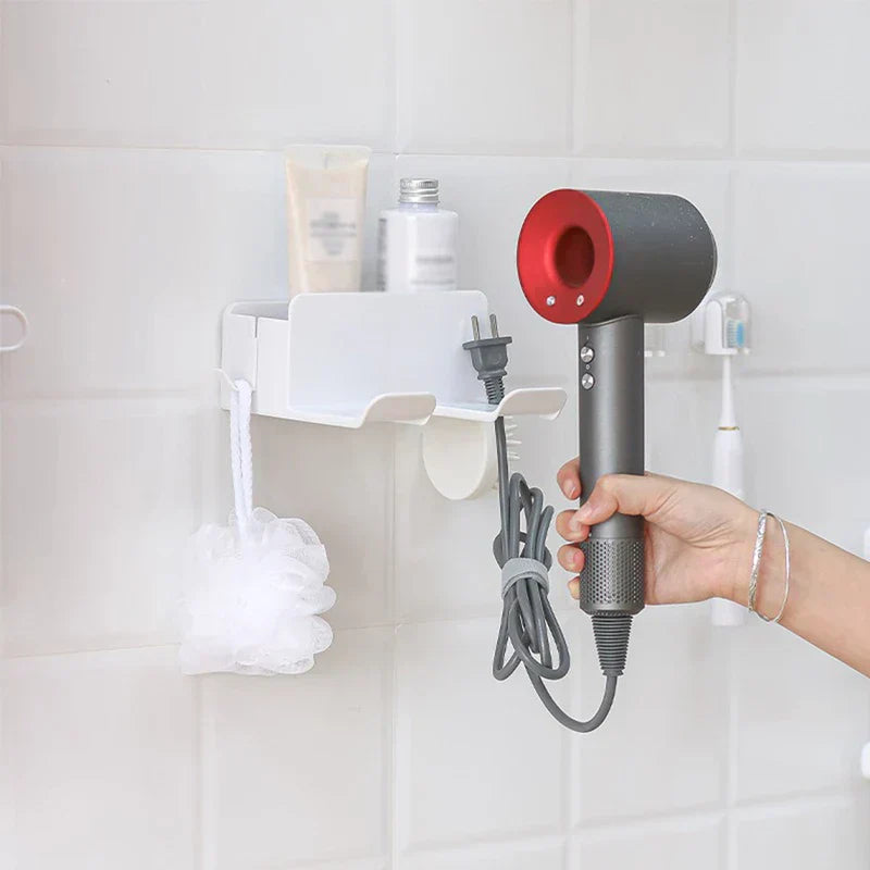 Hair Dryer Organizer - Wall-mounted white storage unit holding toiletries, with a hand holding a gray and red hair dryer nearby
