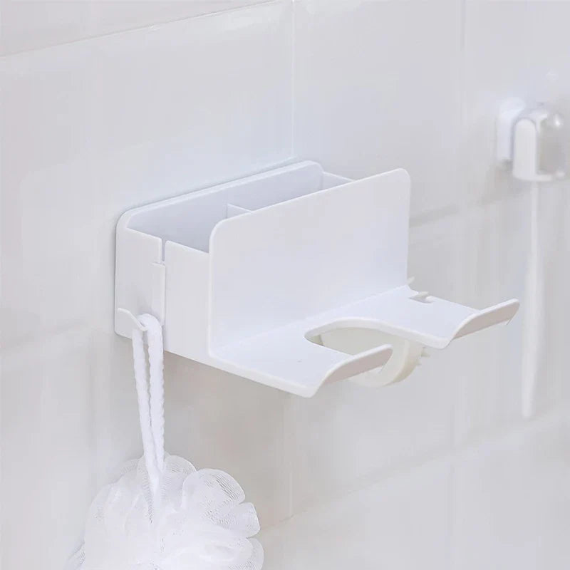 Hair Dryer Organizer - White wall-mounted organizer affixed to a tiled wall, with a white bath loofah hanging from its side hook
