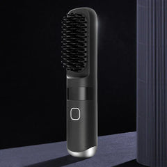 Hair Straightener Brush - Straight-on vertical black cordless heated hair brush standing upright on a dark surface against a dark background