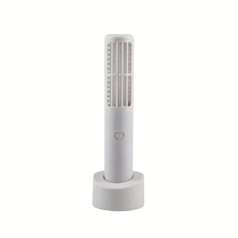 Mini Fan - White upright bladeless fan resting on its matching round charging base, with heart-shaped control button