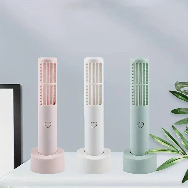 Mini Fan - Three bladeless fans in pink, white, and light sage displayed on their matching bases on a desktop