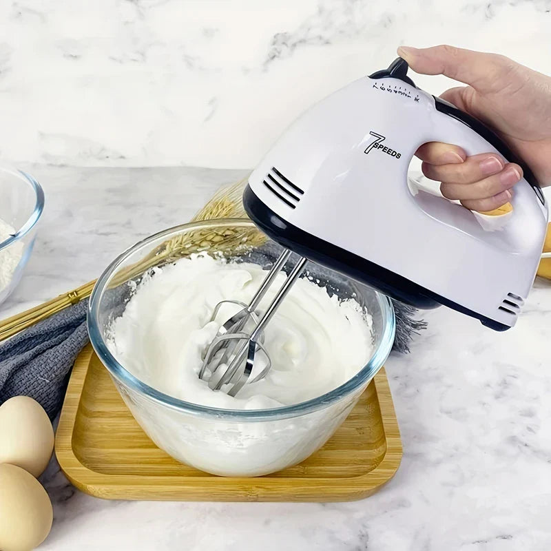 Handheld electric drink mixer whisk in use with coffee
