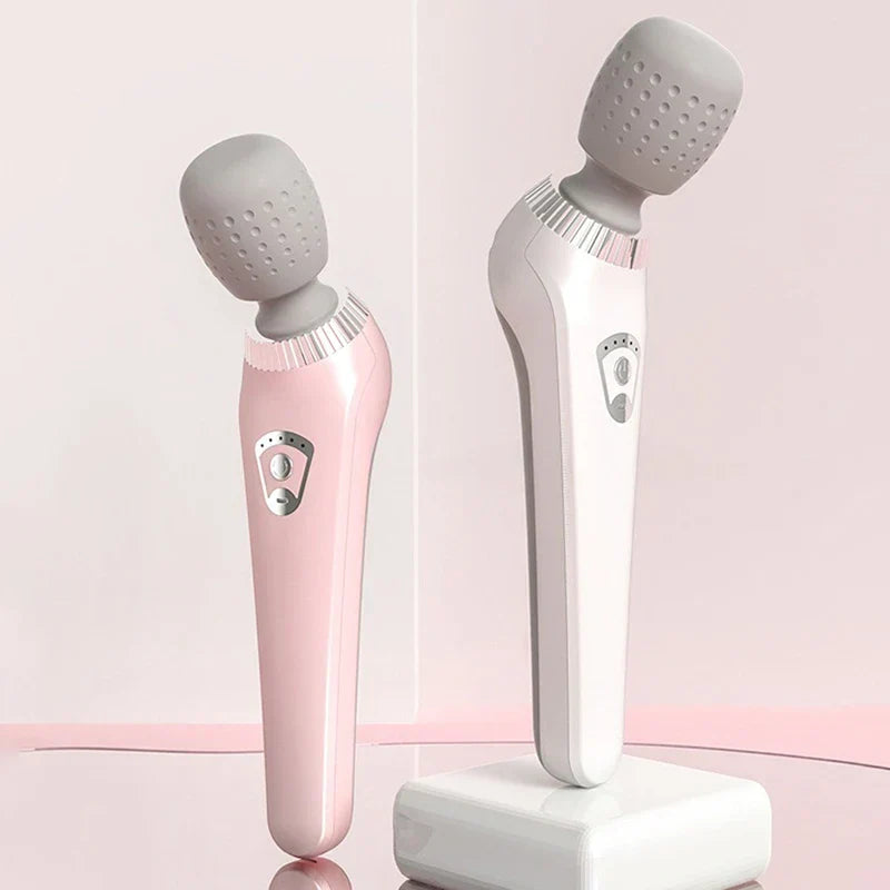 Handheld Body Massager - Two massager units in pink and white finishes displayed upright against a light pink background