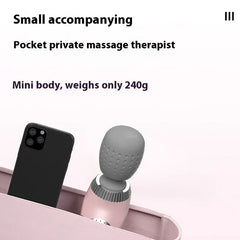 Handheld Body Massager - Mini pink massager shown next to a smartphone inside a bag, demonstrating compact portable size