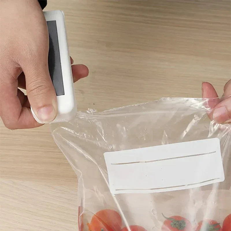 Handheld Heat Sealer - Sealer being used to seal a clear plastic produce bag holding cherry tomatoes