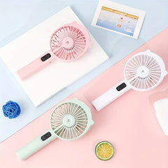 Handheld Misting Fan - Three color options laid flat, showing handheld form factor