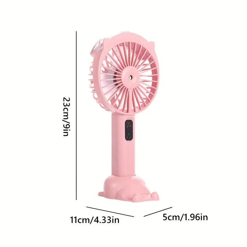 Handheld Misting Fan - Pink handheld fan with cat-ear design, shown with dimension labels: 23cm tall, base 11cm by 5cm.