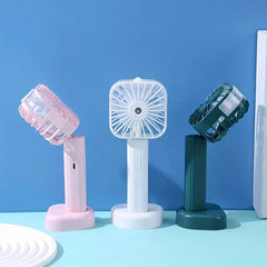 Mist Sprayer - Three mist fans in pink, white, dark green on their bases, showing adjustable tilted fan heads.