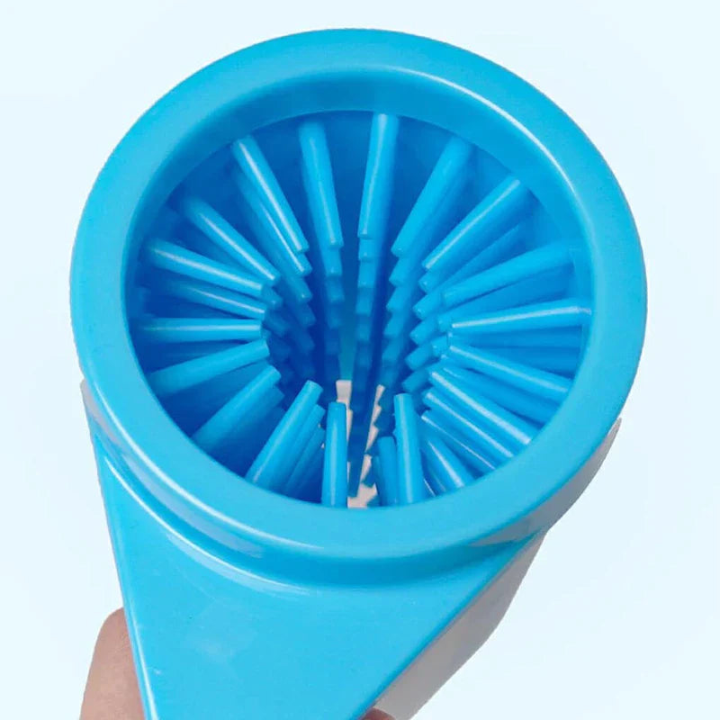 Handle - Top-down close-up view into the opening of a blue pet paw washer, showing radiating internal bristle structure