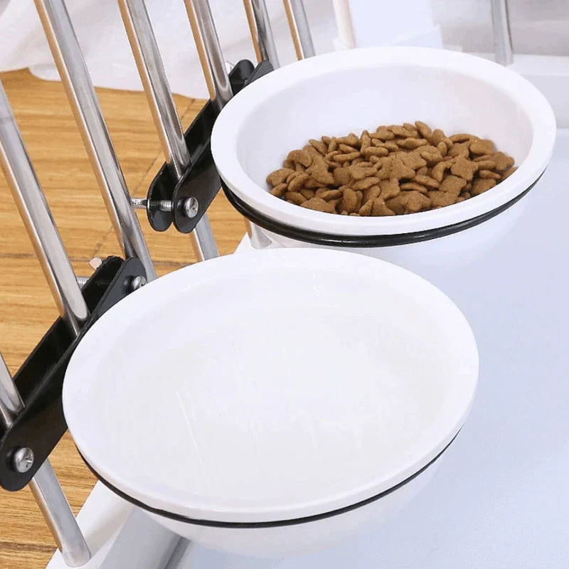 Two hanging crate pet bowl feeder water dishes mounted to a wire crate, one with kibble and one empty