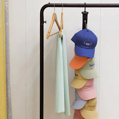Hat Organizer - Cap hanger hung on a clothing rack, holding stacked baseball caps
