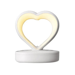 Humidifier - White heart-shaped unit with warm integrated glow light on round base