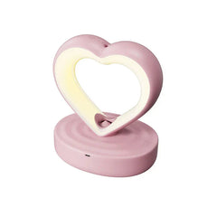 Pink heart-shaped humidifier/night light against a plain white background, with no mist or water droplets present