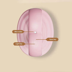 Humidifier - Top-down view of pink unit labeling mist outlet, power control, and light control buttons