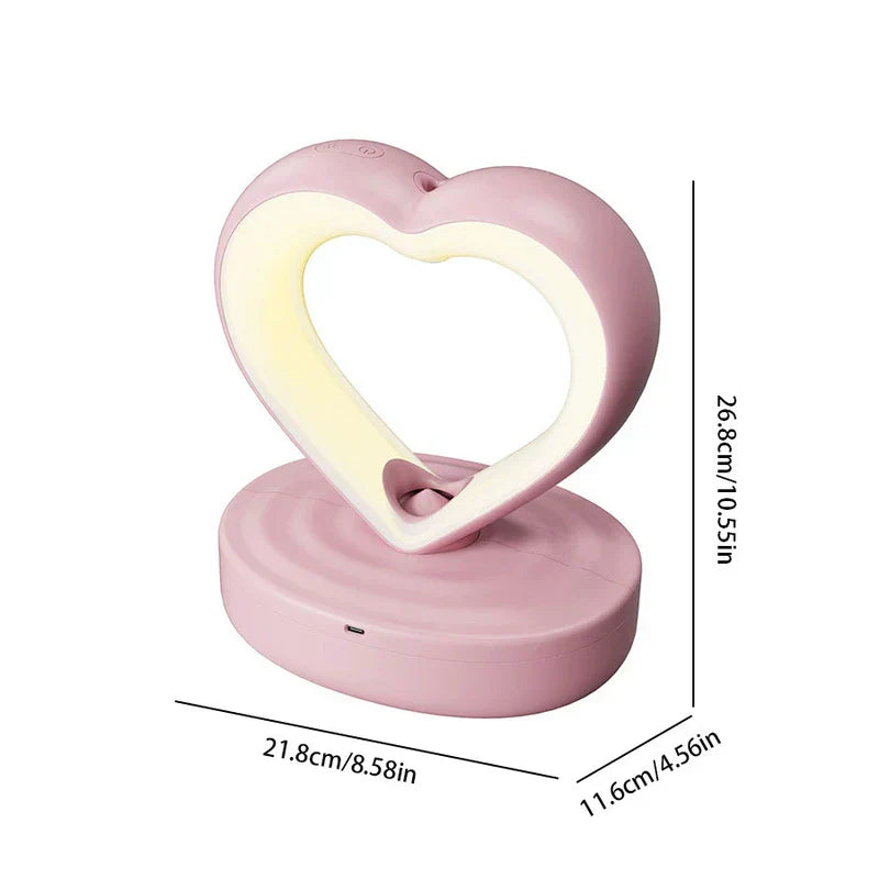 Humidifier - Pink heart-shaped device with illuminated inner ring, shown on its base with height, width, and depth measurements marked.