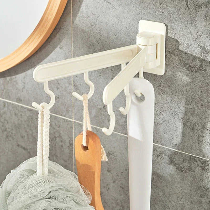 Adhesive Wall Hooks - Rotating hook rack installed on a gray tiled bathroom wall, holding a loofah, wooden bath brush, and white hanging strap