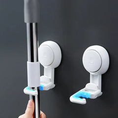 Suction Cup Hook - Two wall-mounted hooks holding a metal cleaning tool handle, with blue grip lining