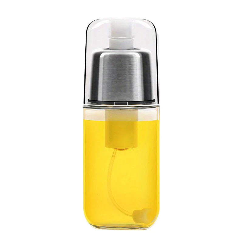 Oil Mister Sprayer - Clear spray bottle filled with yellow cooking oil, with stainless steel spray top and clear protective cap