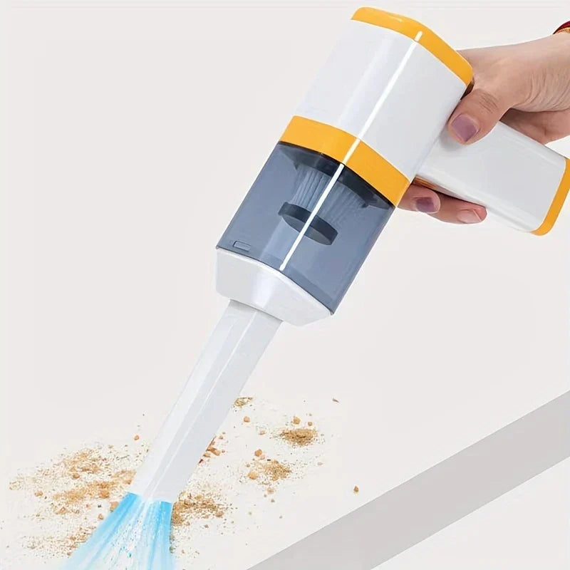 Car Vacuum Cleaner - Hand holding the handheld vacuum with a crevice tool, clearing debris from a white flat surface