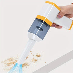 Car Vacuum Cleaner - Hand holding the handheld vacuum with a crevice tool, clearing debris from a white flat surface