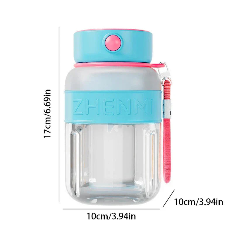 This smoothie maker tumbler bottle has blue-pink accents, a pink wrist strap, and measures 17cm tall by 10cm wide against a white background.
