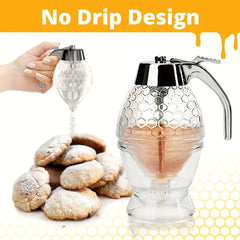 Dispensador de miel con palo removedor - Dispensador de miel con diseño sin goteo, espolvoreando azúcar glas sobre galletas; se muestra el dispensador transparente y cromado