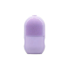 Facial Massager - Light purple silicone skincare device with raised bristle cleansing surface on upper half, smooth ergonomic grip on lower half