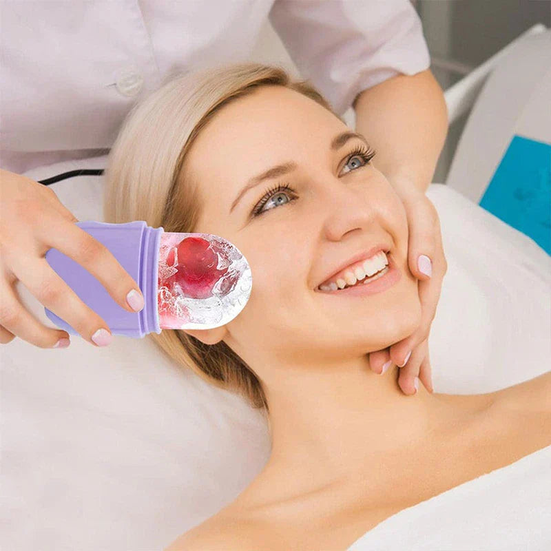 Facial Massager - Esthetician holding the ice application end of the lavender device against a client’s cheek during a facial treatment