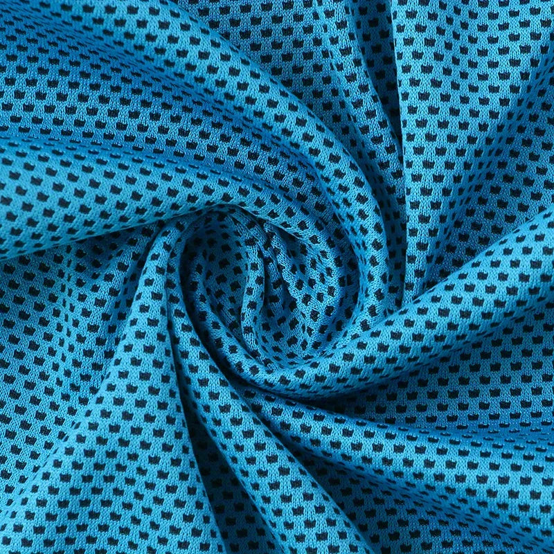 Cooling Towel - Close-up of swirled bright blue knit fabric with a repeating small dark square mesh pattern