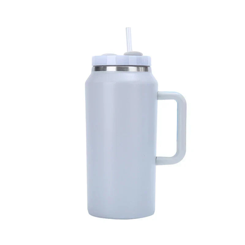 Car Travel Mug - Light blue insulated tumbler with a side handle, lid with flip-up tab, and a plastic straw inserted through the lid.