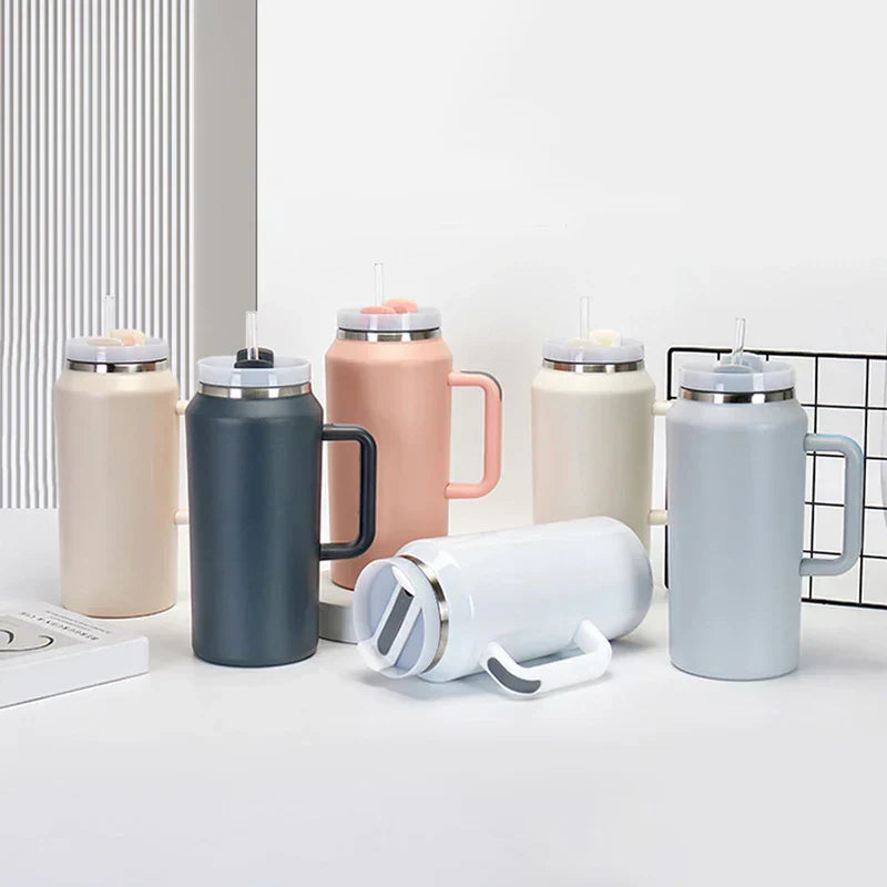Car Travel Mug - Assorted neutral-toned tumblers with handles and straw lids arranged on a tabletop