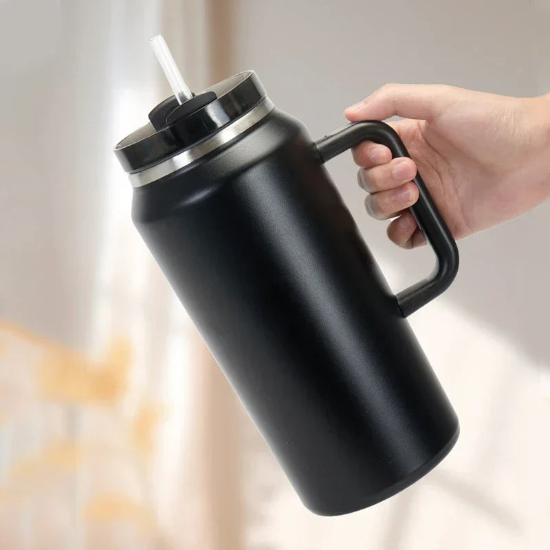 Car Travel Mug - Matte black tumbler with handle and straw lid held by a hand