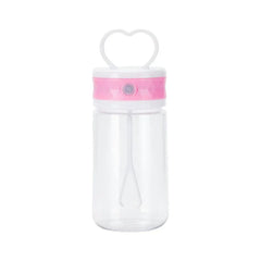 Insulated Coffee Travel Mug - Clear travel tumbler with pink accent band, heart-shaped carry handle, and internal mixing whisk, empty against white background