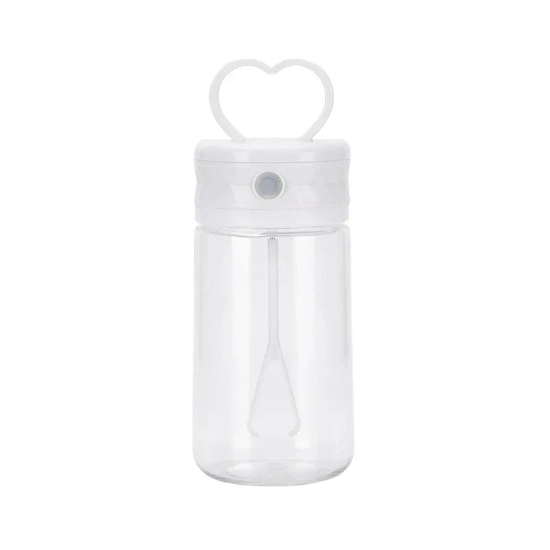Insulated Coffee Travel Mug - Clear empty plastic bottle with white heart handle lid, showing interior mixing paddle, on plain white background