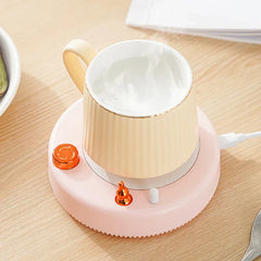 Insulated Mug - Pink USB powered mug warmer holding a pale cream ribbed ceramic mug with steaming liquid inside