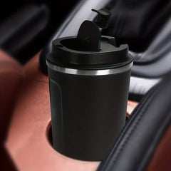 Stainless steel coffee travel mug on a table