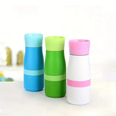 Stainless Steel Tumbler Cup - Three water bottles in blue, green, and white with pink accents standing upright on a light surface