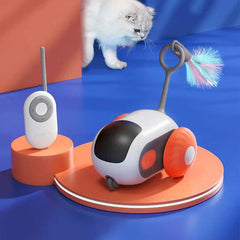 Electronic Cat Chase Toy Car - Silver cat approaching the toy unit, remote placed on a small raised orange stand
