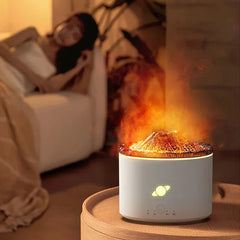 Flame Diffuser Humidifier - Unit operating with warm orange flame-style mist effect, placed on a wooden nightstand next to a bed with a resting person