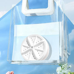 Mini Washer - White compact ultrasonic portable mini washing machine turbine, inside a clear transparent PVC tote bag against a light blue sky background.
